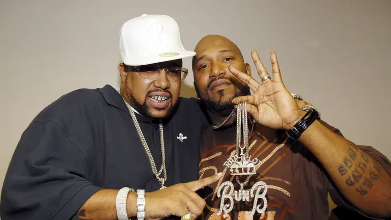 Pimp C in a white cap and Bun B posing together, chains and grills, the Trill standard