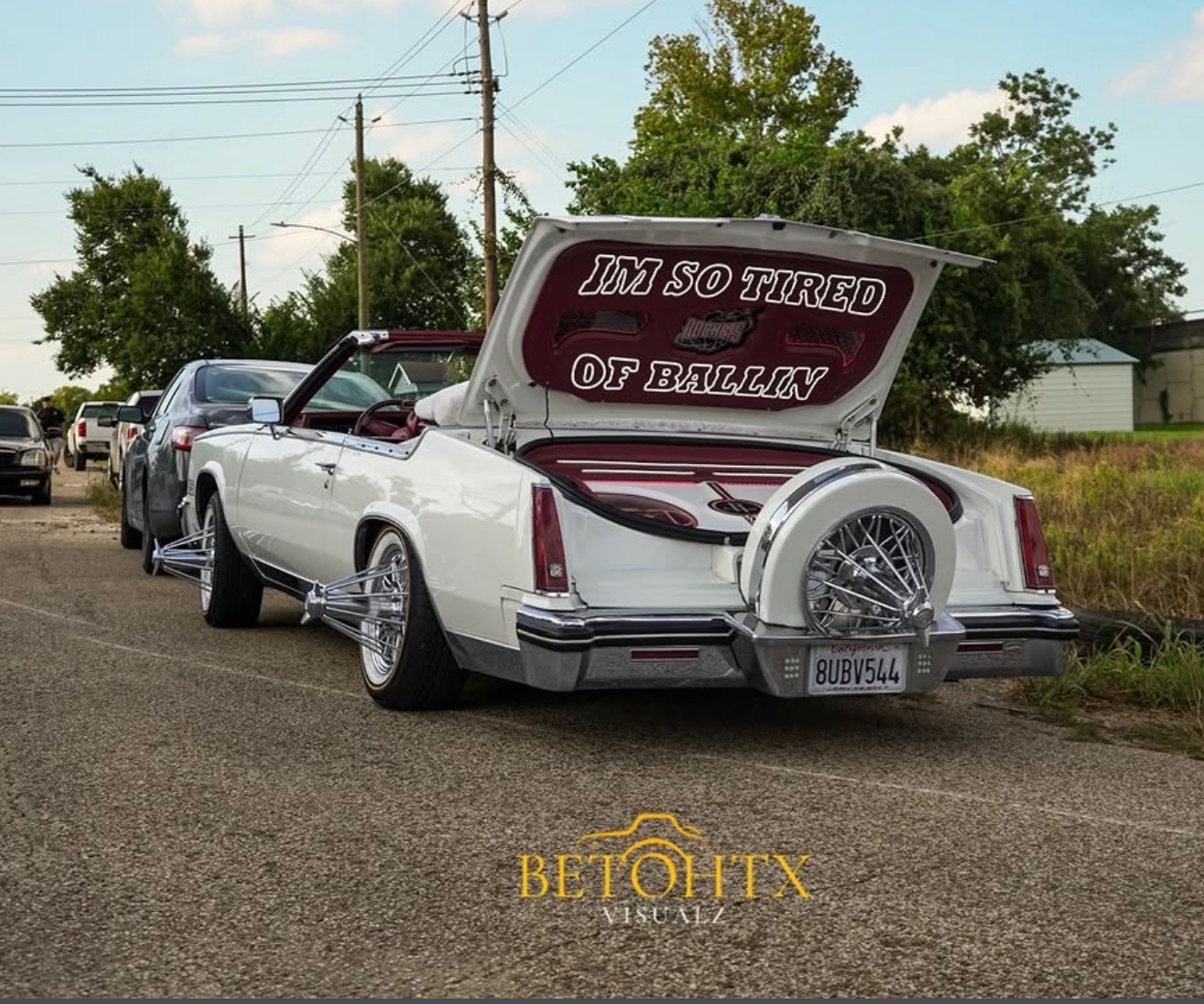 White Cadillac convertible slab on poked-out swangas with a lettered trunk