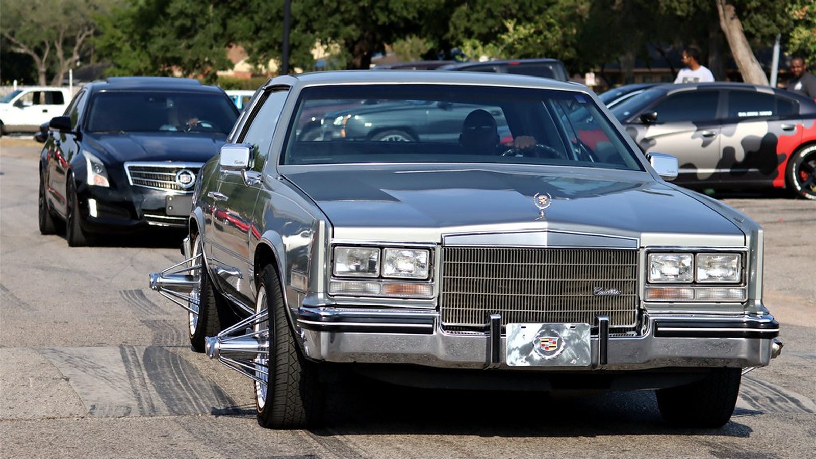 Chrome Cadillac Coupe DeVille slab lined up with other big bodies on wire wheels