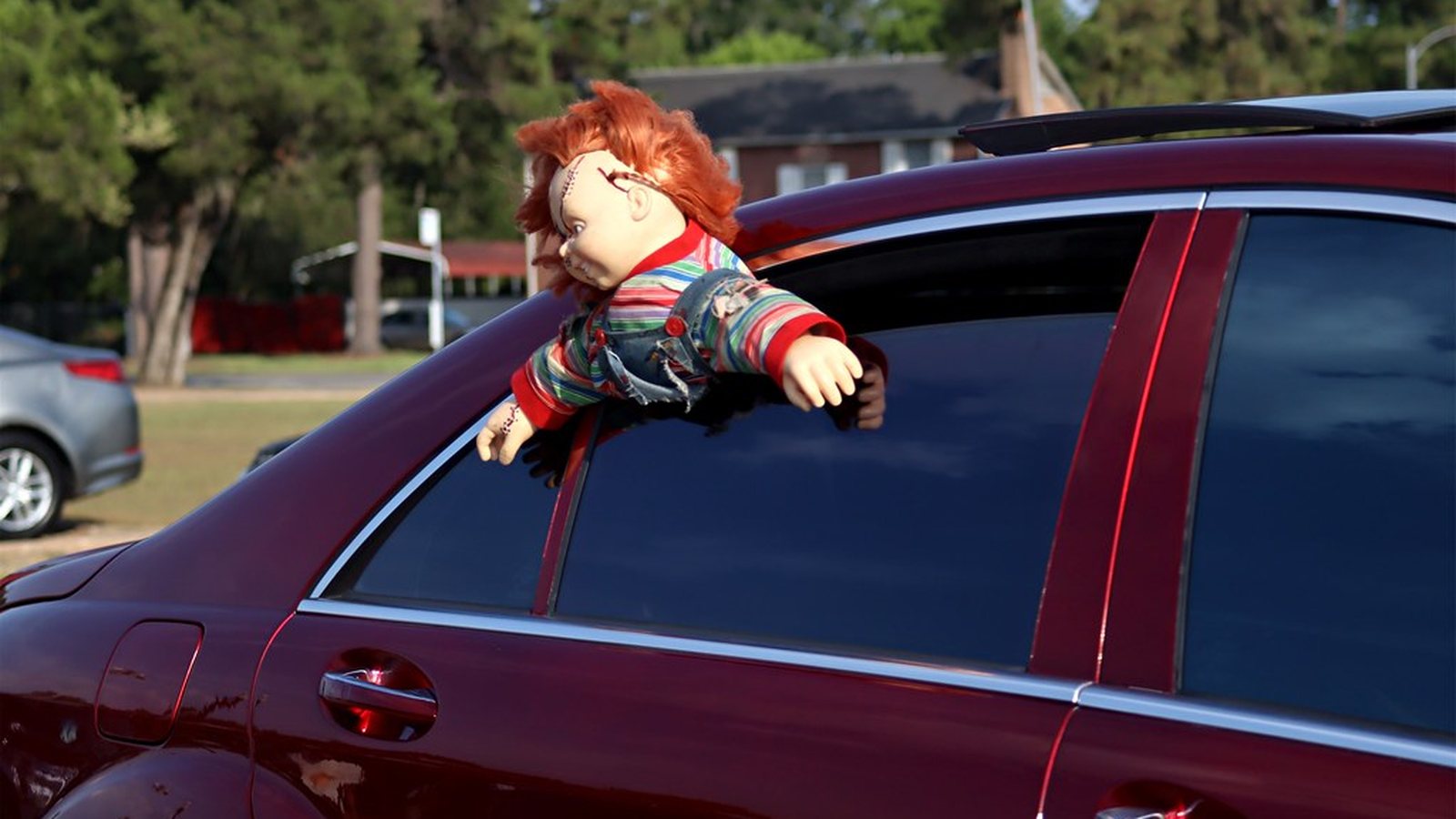 Candy burgundy slab with the window down showing custom interior detail