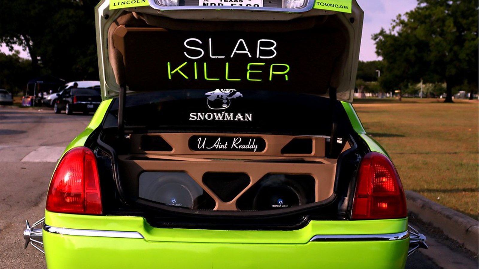 Lincoln slab pop trunk packed with subwoofers and lettered speaker box